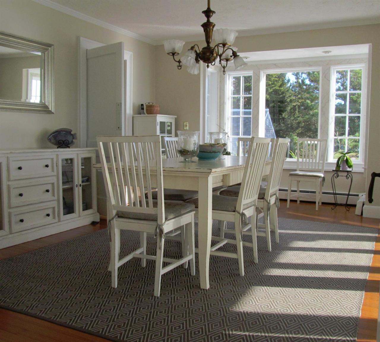 104 Rocky Point Road Bourne, MA 02532 - Photo 11 of 22 a view of a dining room with furniture wooden floor and chandelier