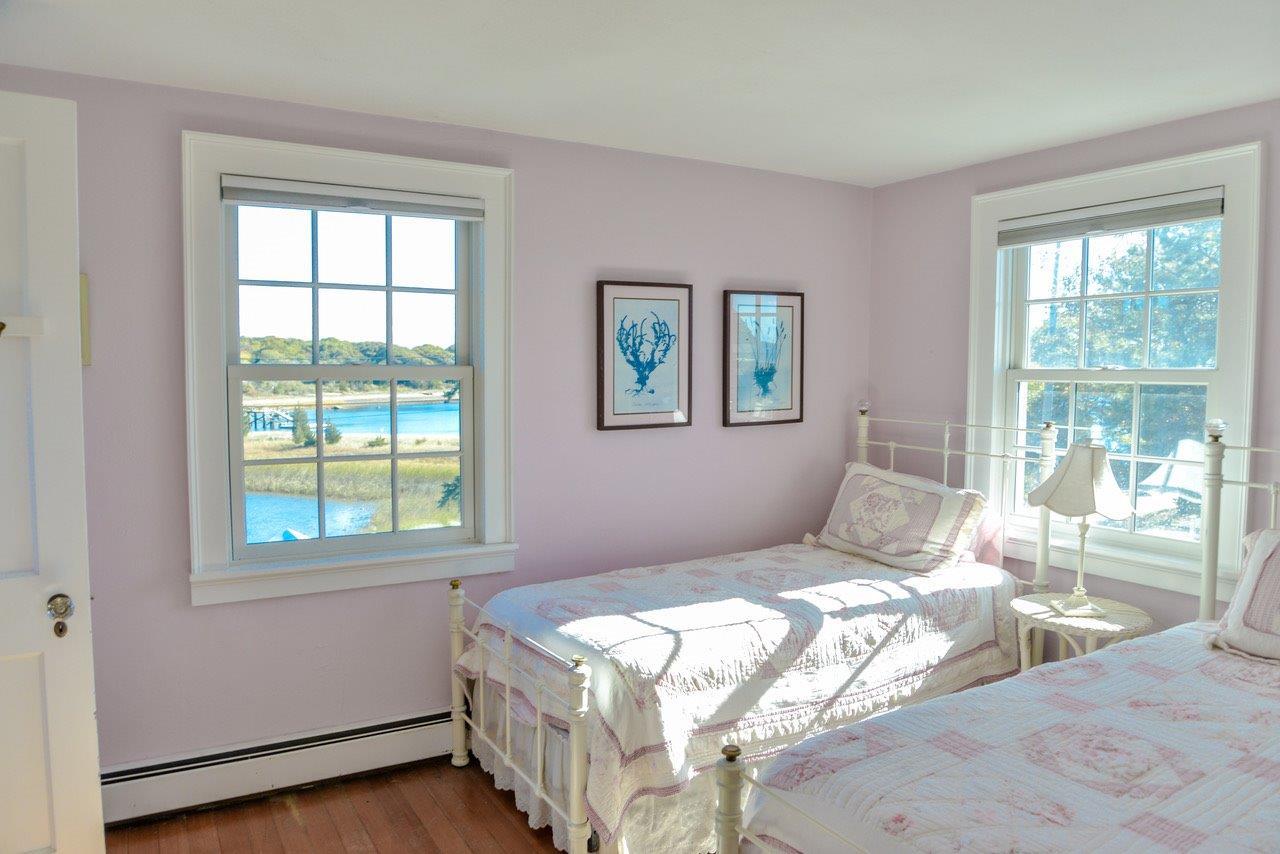 104 Rocky Point Road Bourne, MA 02532 - Photo 14 of 22 a bedroom with a large bed and a window