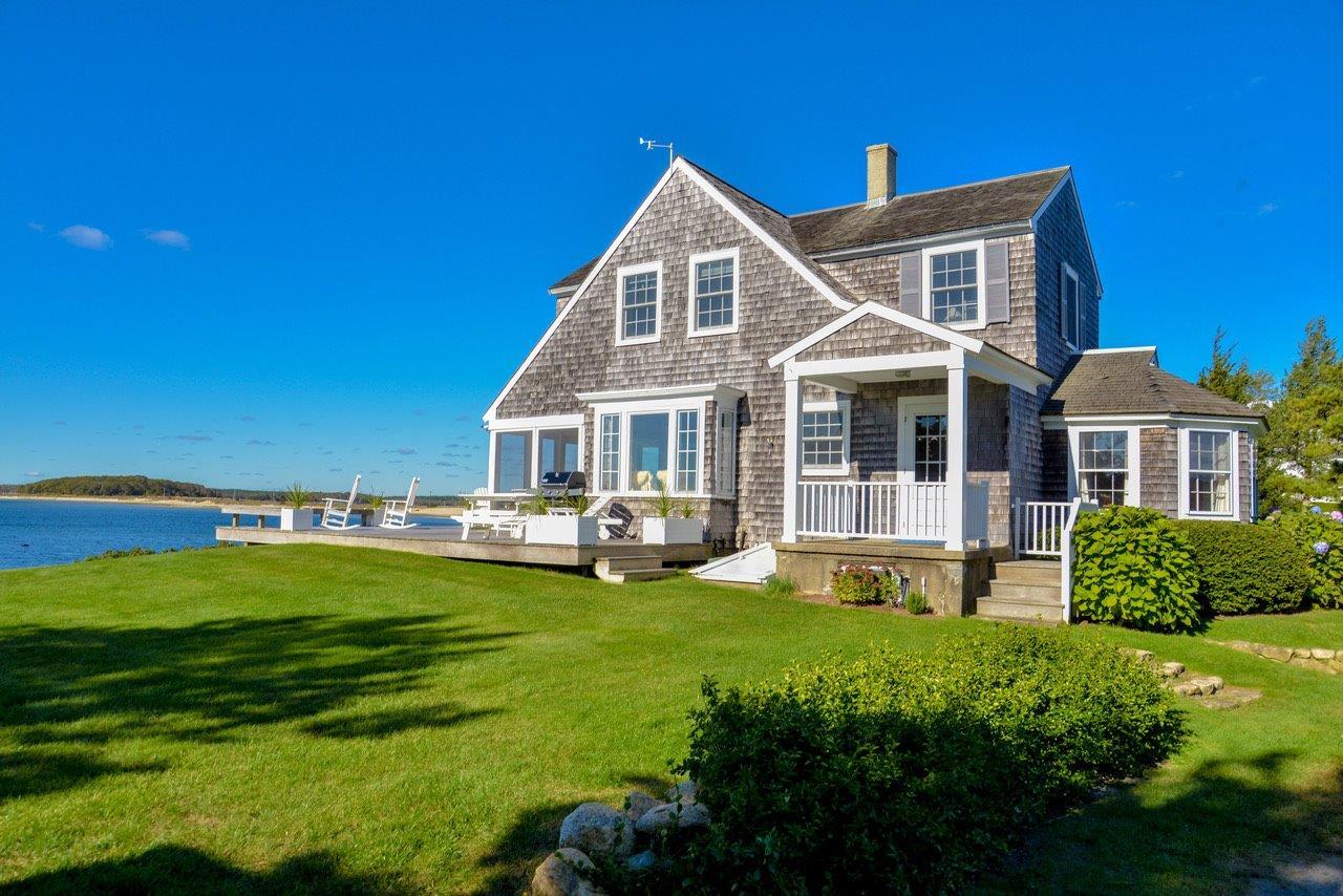 104 Rocky Point Road Bourne, MA 02532 - Photo 18 of 22 a front view of a house with swimming pool having outdoor seating