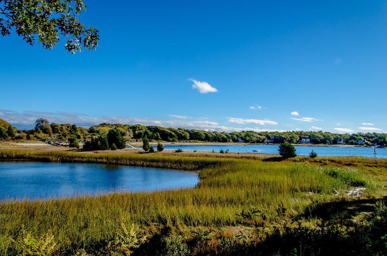 104 Rocky Point Road Bourne, MA 02532 - Photo 21 of 22 a view of a lake with houses in the background