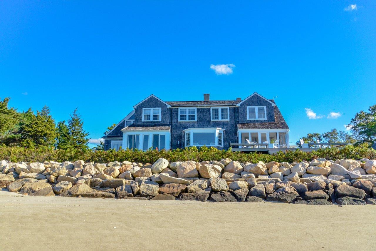 104 Rocky Point Road Bourne, MA 02532 - Photo 3 of 22 a front view of a house with a big yard and potted plants