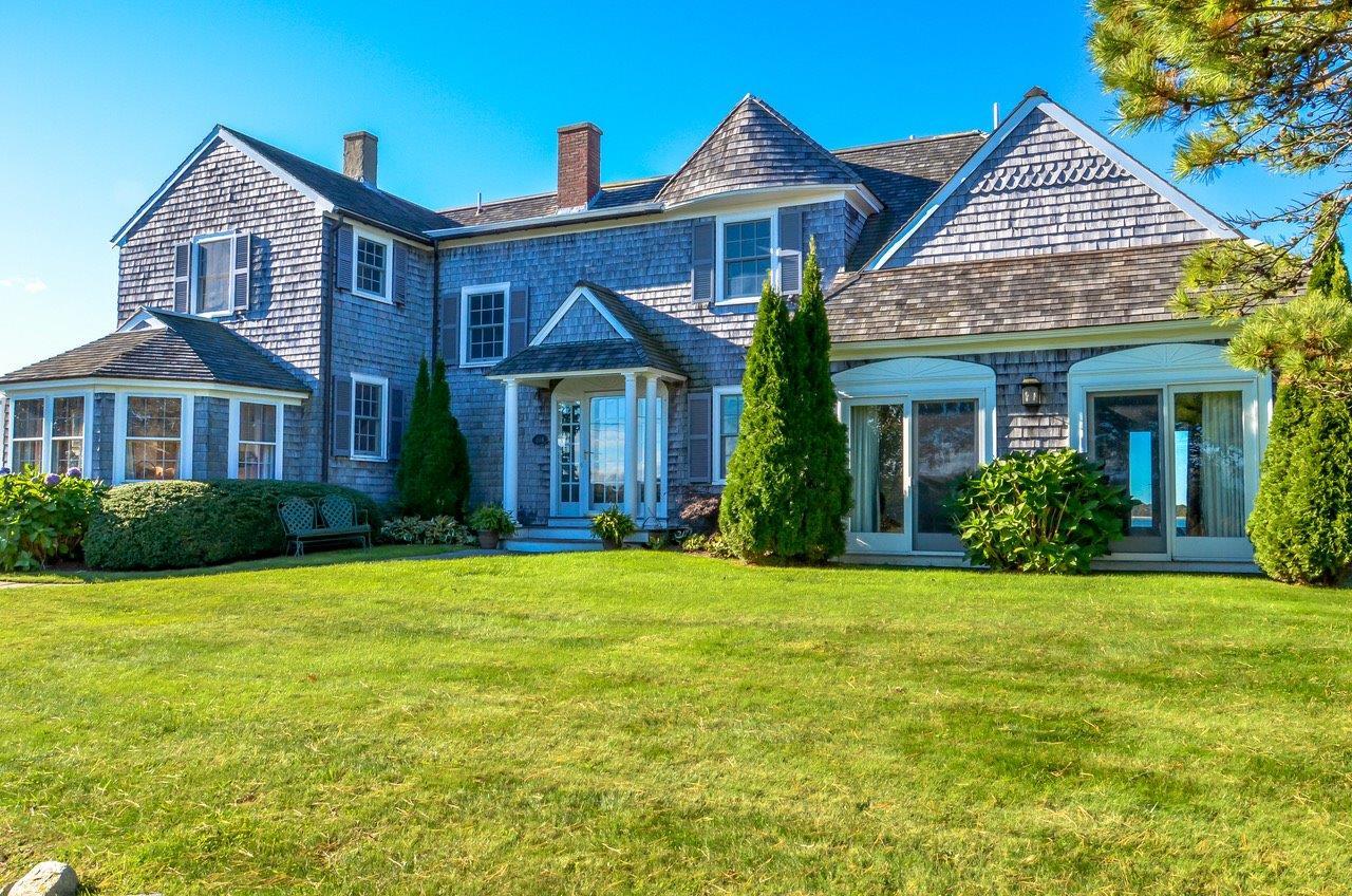 104 Rocky Point Road Bourne, MA 02532 - Photo 4 of 22 a front view of a house with a yard