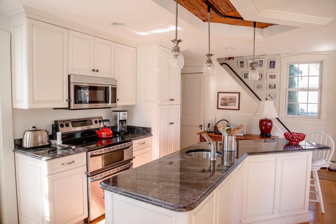 104 Rocky Point Road Bourne, MA 02532 - Photo 7 of 22 a kitchen with stainless steel appliances granite countertop a sink a stove and a refrigerator