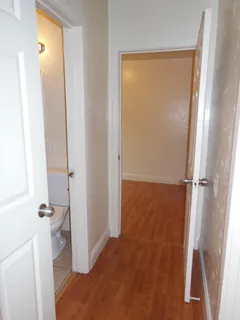 a view of an empty room and wooden floor
