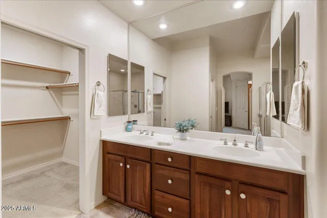 a bathroom with a double vanity sink and a mirror