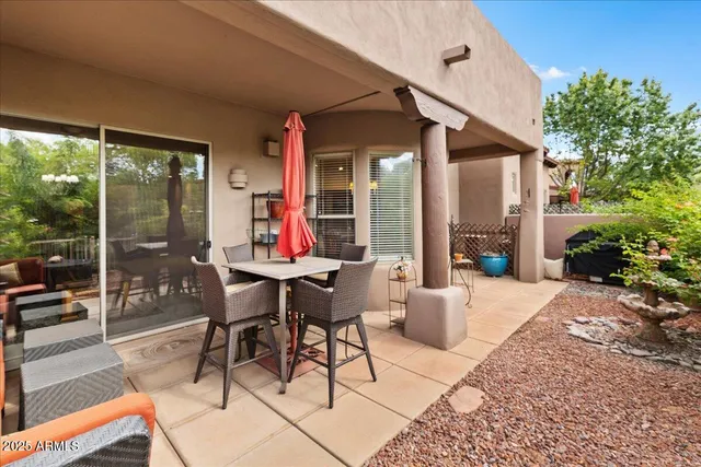 a view of a patio with a dining table and chairs