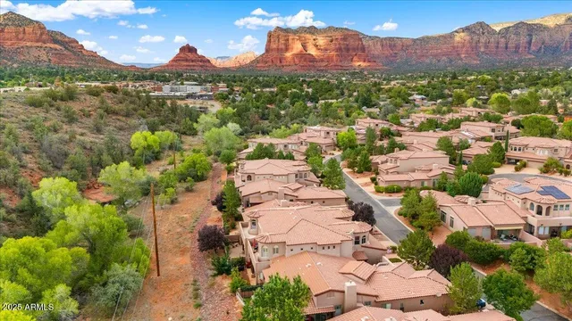 an aerial view of residential houses with outdoor space and seating