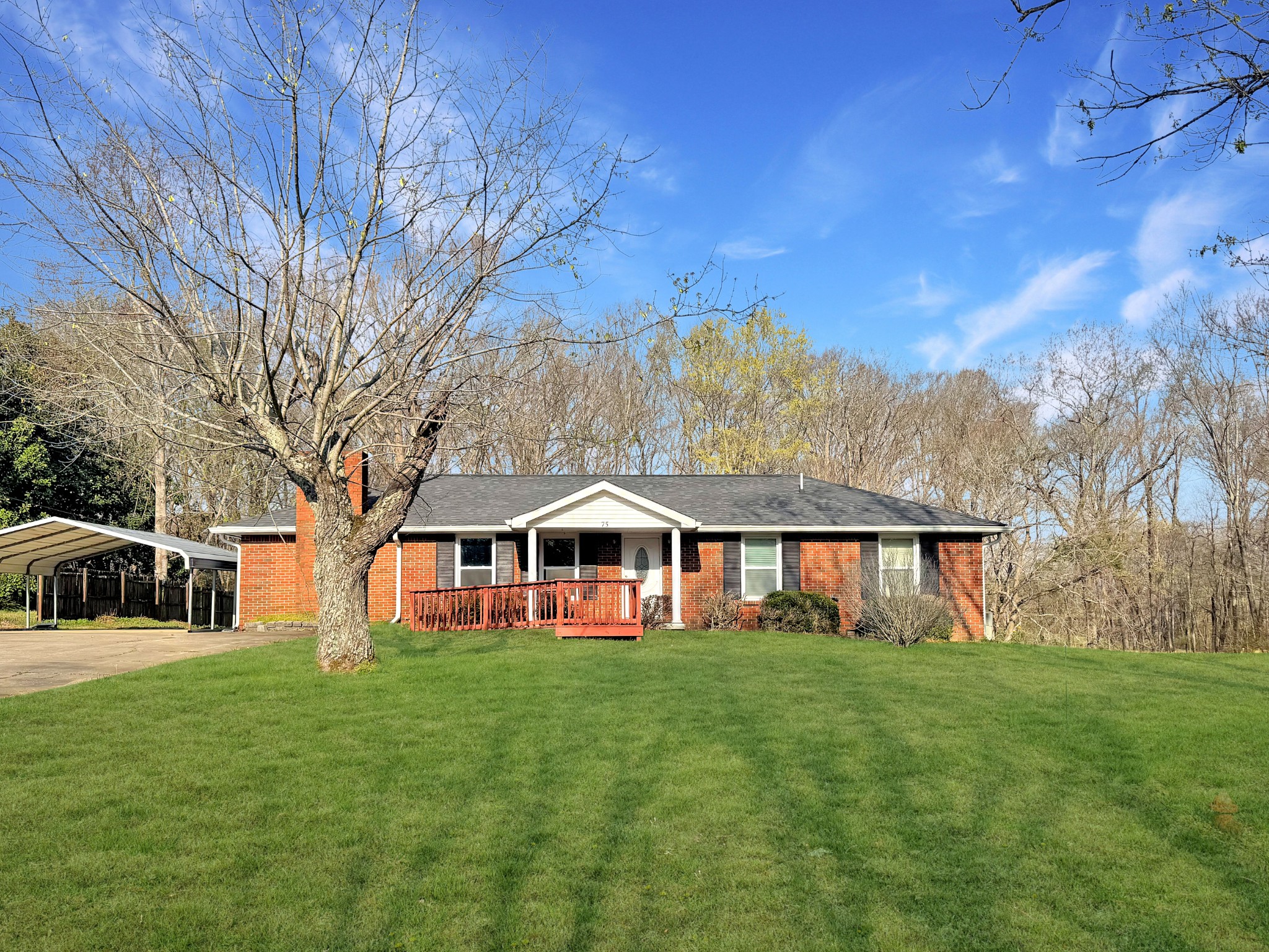 75 Towering Oaks Road Tennessee Ridge, TN 37178 - Photo 1 of 18 a front view of a house with a yard