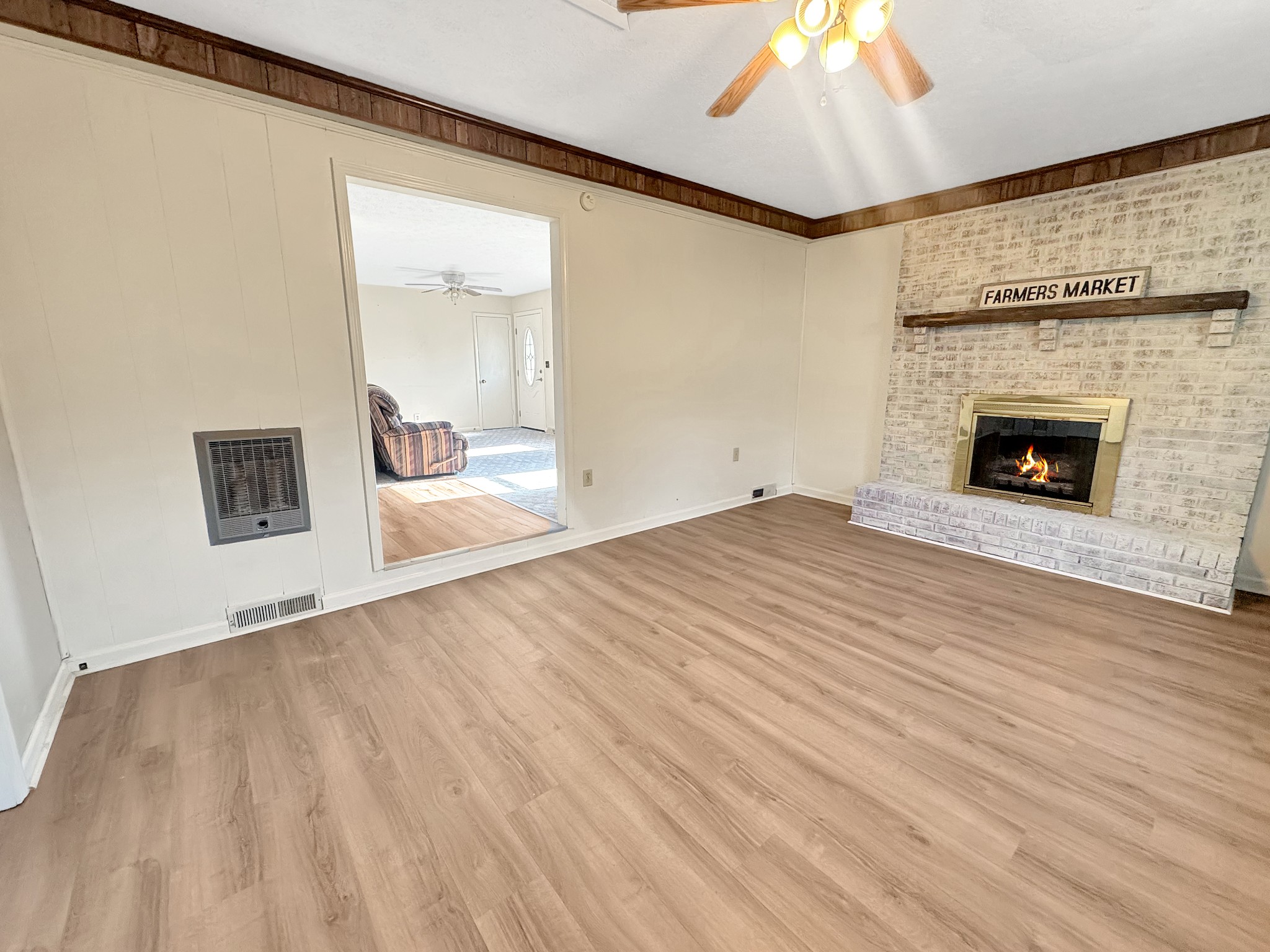 75 Towering Oaks Road Tennessee Ridge, TN 37178 - Photo 4 of 18 a view of empty room with wooden floor and fireplace