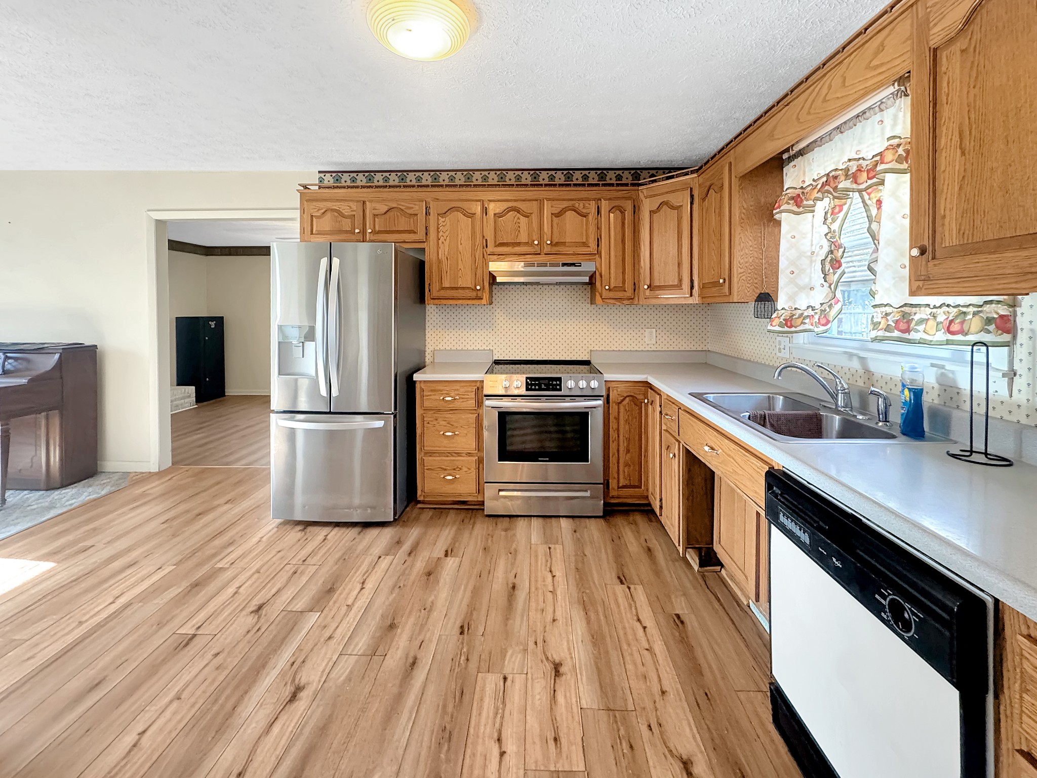 75 Towering Oaks Road Tennessee Ridge, TN 37178 - Photo 7 of 18 a kitchen with a sink a kitchen island wooden floor and stainless steel appliances