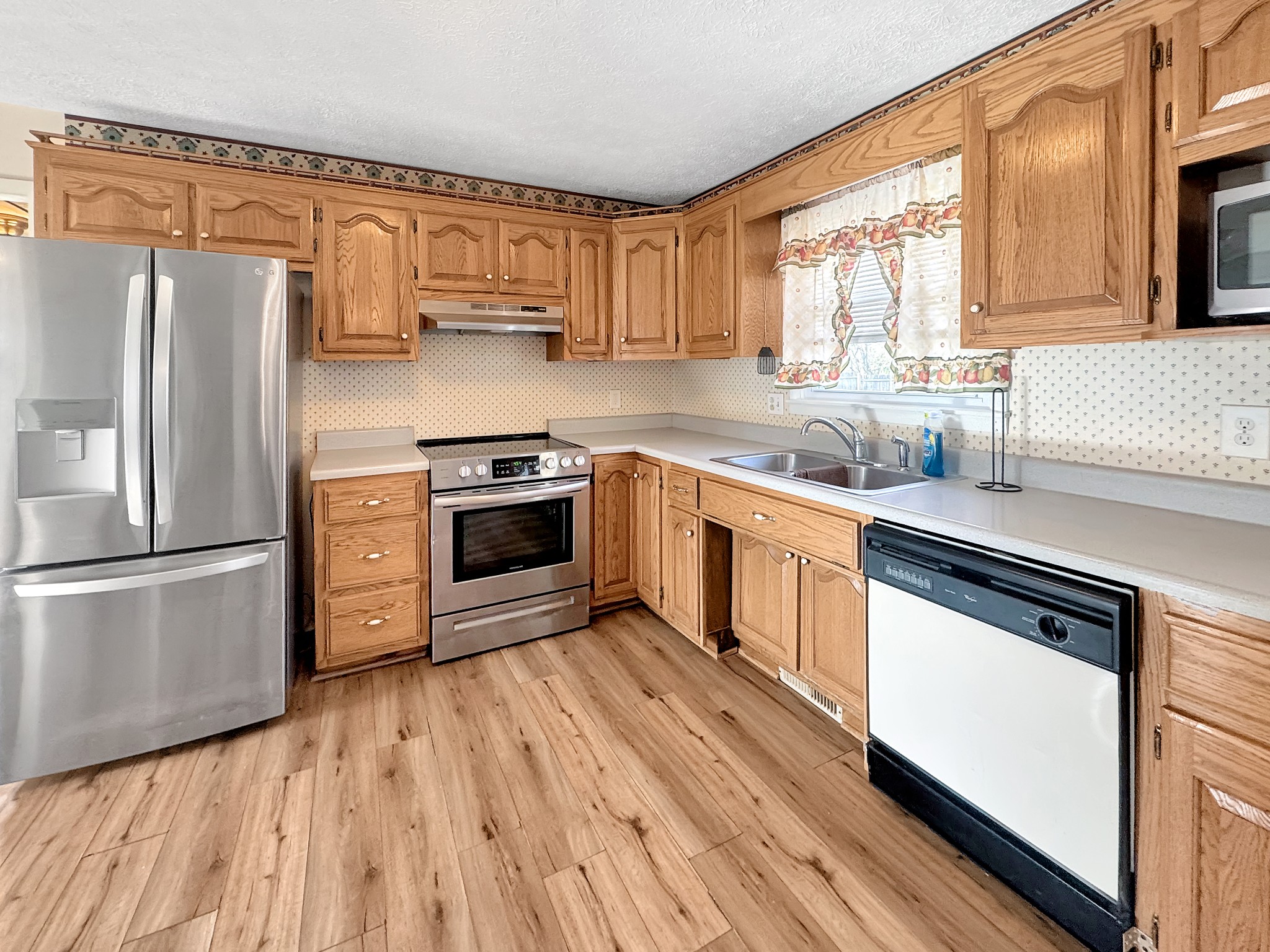 75 Towering Oaks Road Tennessee Ridge, TN 37178 - Photo 8 of 18 a kitchen with a stove a sink and a refrigerator
