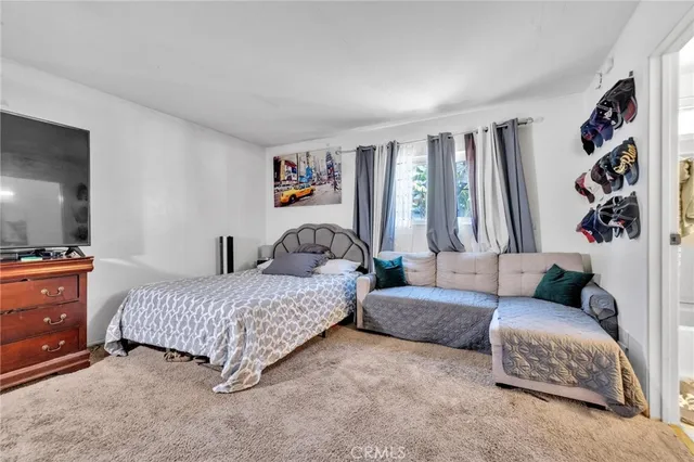 a bedroom with bed and a couch