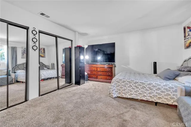 a bedroom with a bed and a dresser