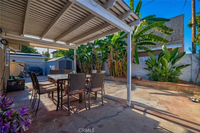 a view of a patio with table and chairs and potted plants