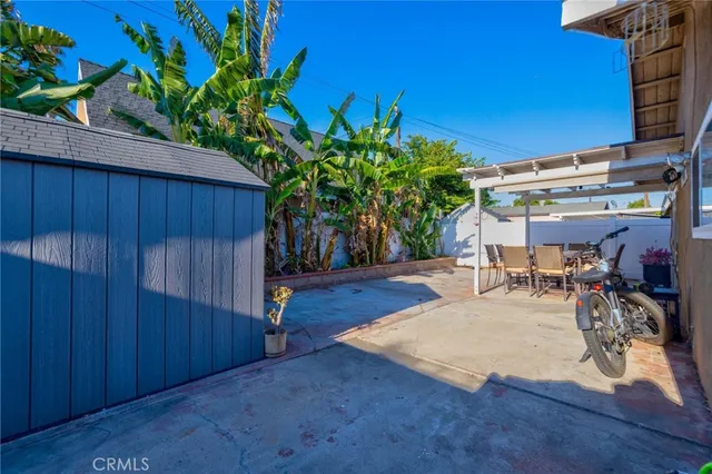 a view of a room with wooden floor and potted plant