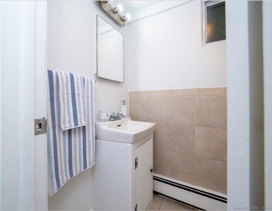 74 Lakeview Avenue New Canaan, CT 06840 - Photo 11 of 15 a bathroom with a sink a toilet and shower