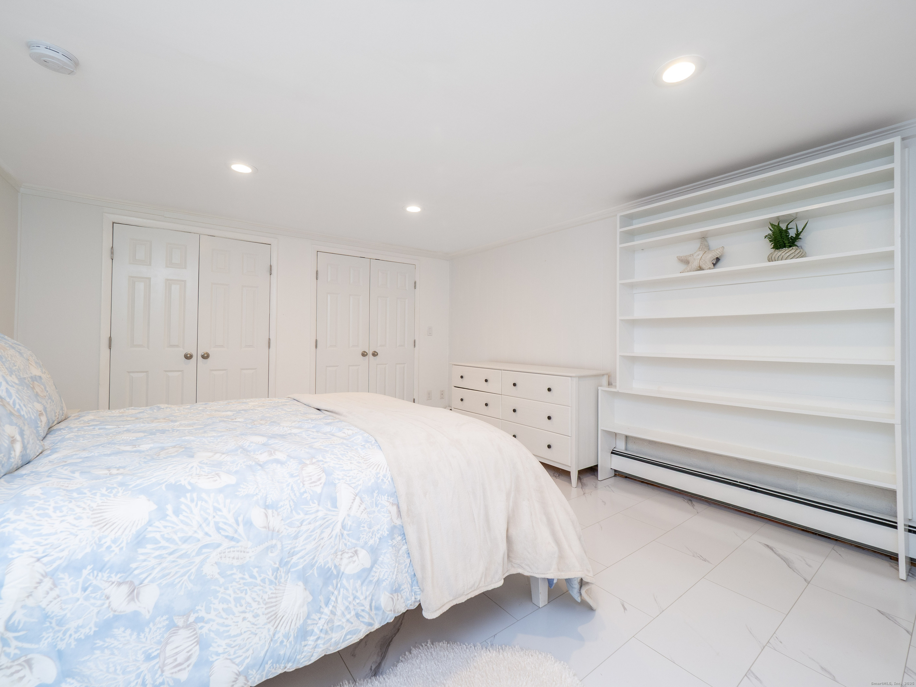 74 Lakeview Avenue New Canaan, CT 06840 - Photo 5 of 15 a bedroom with a bed and cabinet