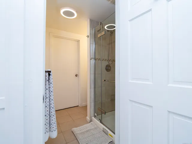 a bathroom with a glass shower door