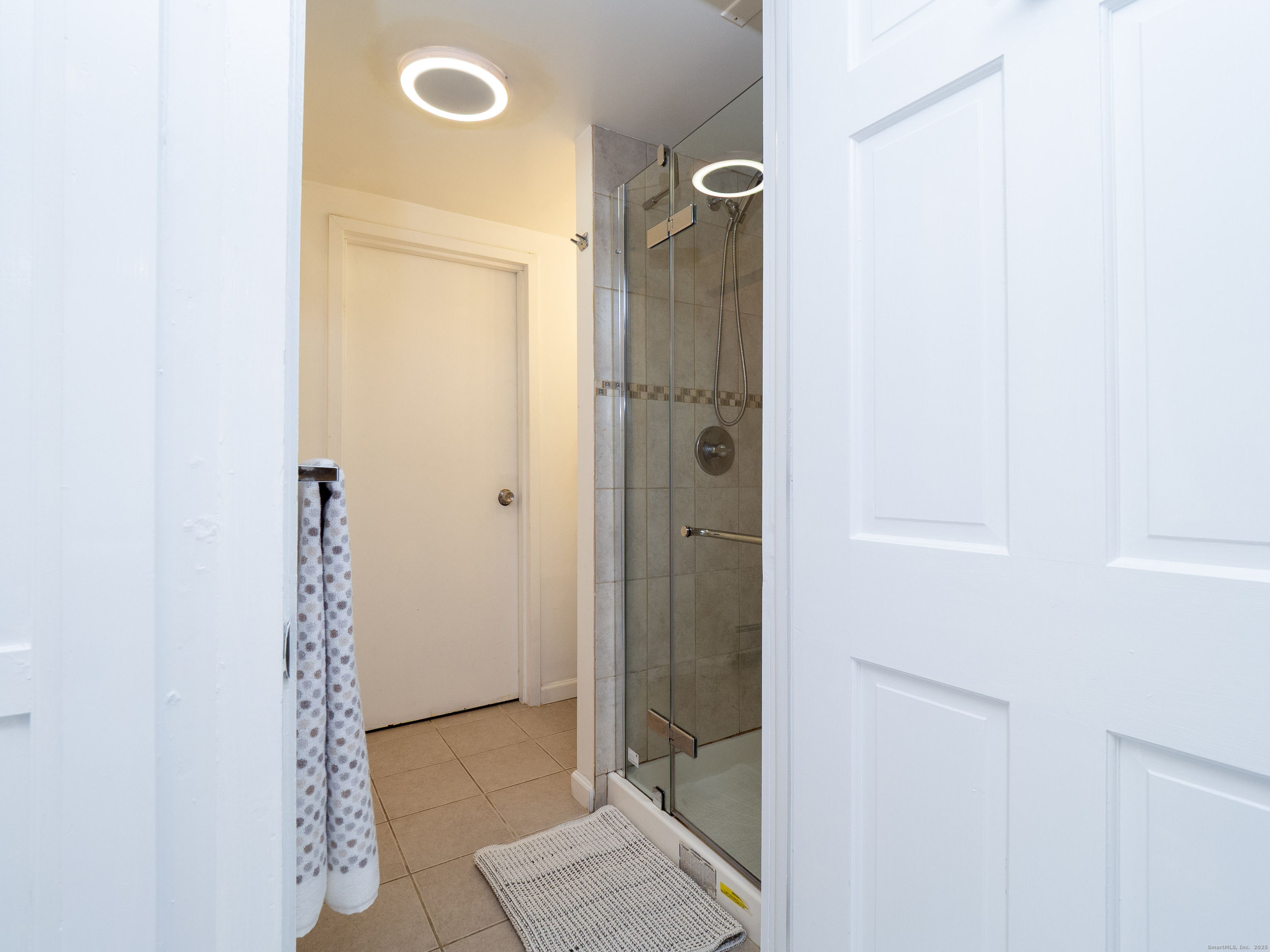 74 Lakeview Avenue New Canaan, CT 06840 - Photo 7 of 15 a bathroom with a glass shower door