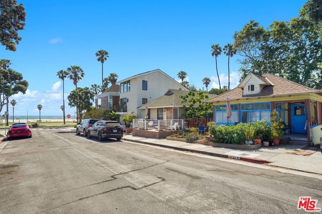 a view of a house with a garden and pathway