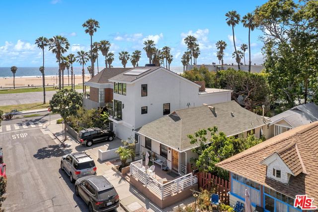 an aerial view of multiple houses with a yard