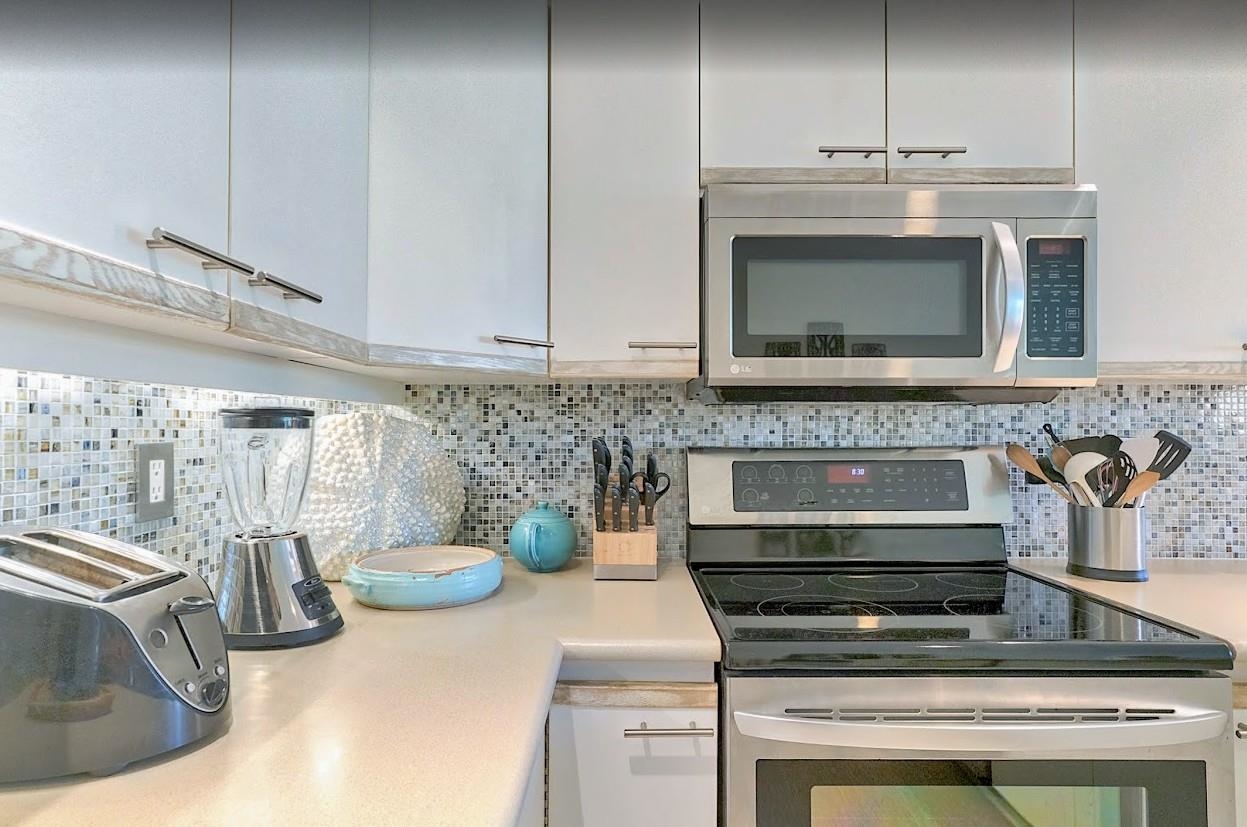 2777 South Kihei Road, Unit D109 Kihei, HI 96753 - Photo 2 of 50 a kitchen with a stove and cabinets