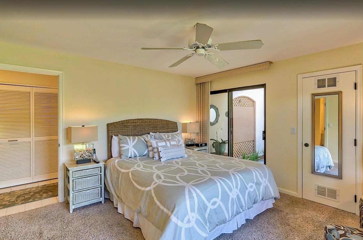 2777 South Kihei Road, Unit D109 Kihei, HI 96753 - Photo 33 of 50 a bedroom with a bed and a chandelier