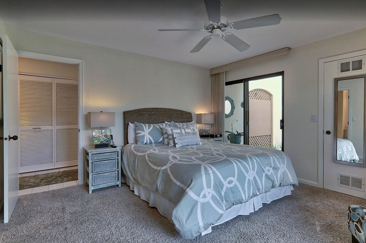 2777 South Kihei Road, Unit D109 Kihei, HI 96753 - Photo 38 of 50 a bedroom with a bed and a chandelier