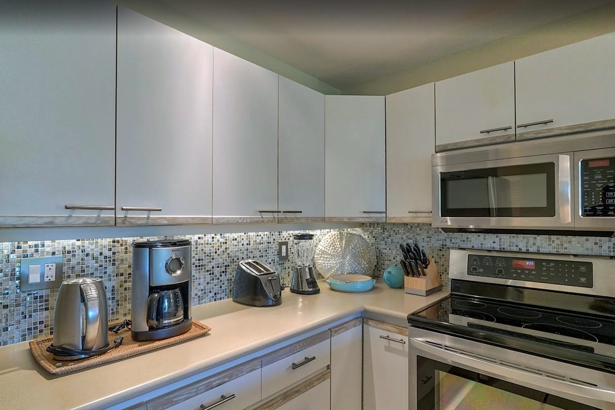2777 South Kihei Road, Unit D109 Kihei, HI 96753 - Photo 10 of 50 a kitchen with a stove and a microwave
