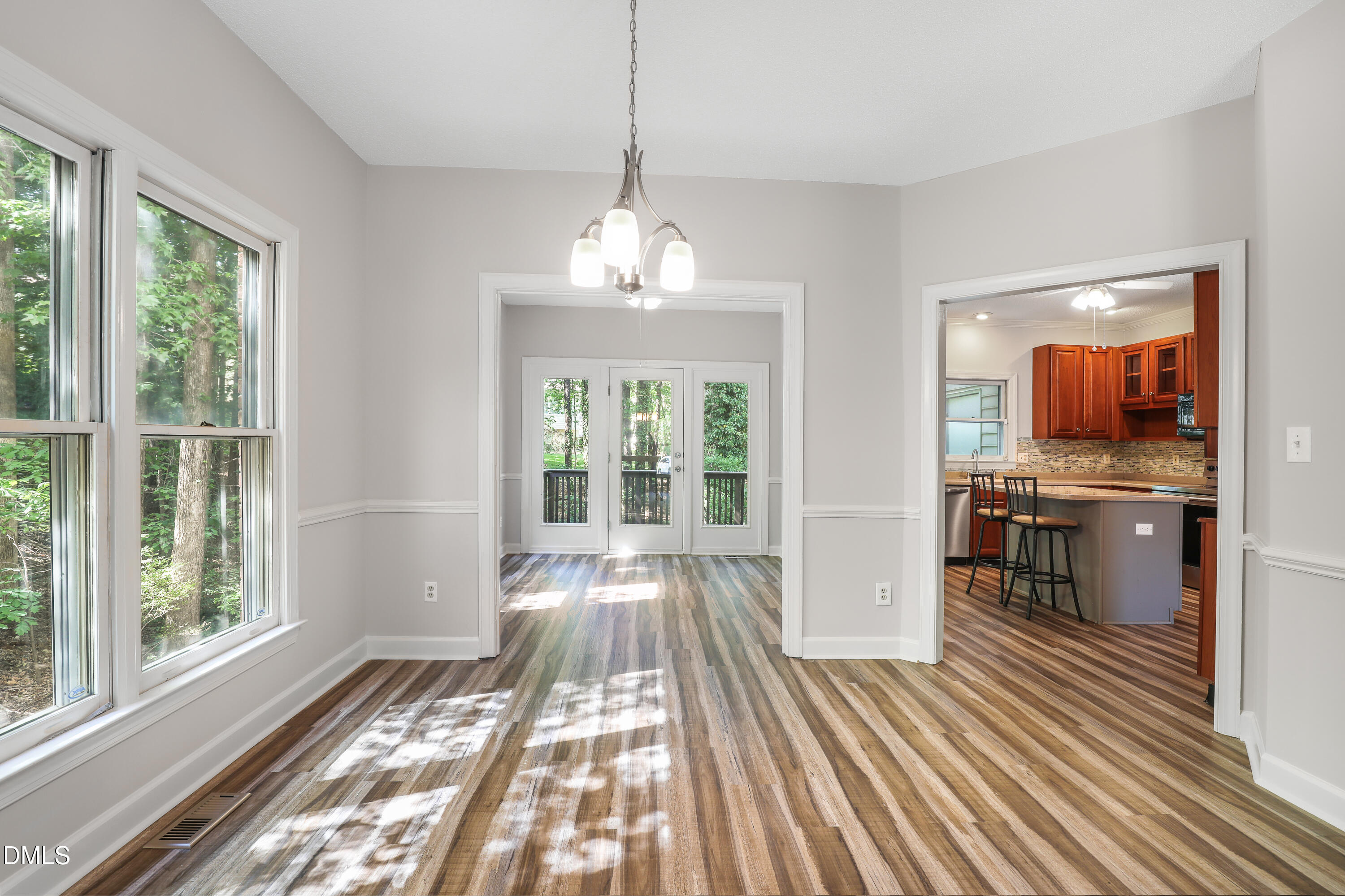 15 Preakness Drive Durham, NC 27713 - Photo 5 of 32 a view of a room with wooden floor windows and kitchen view