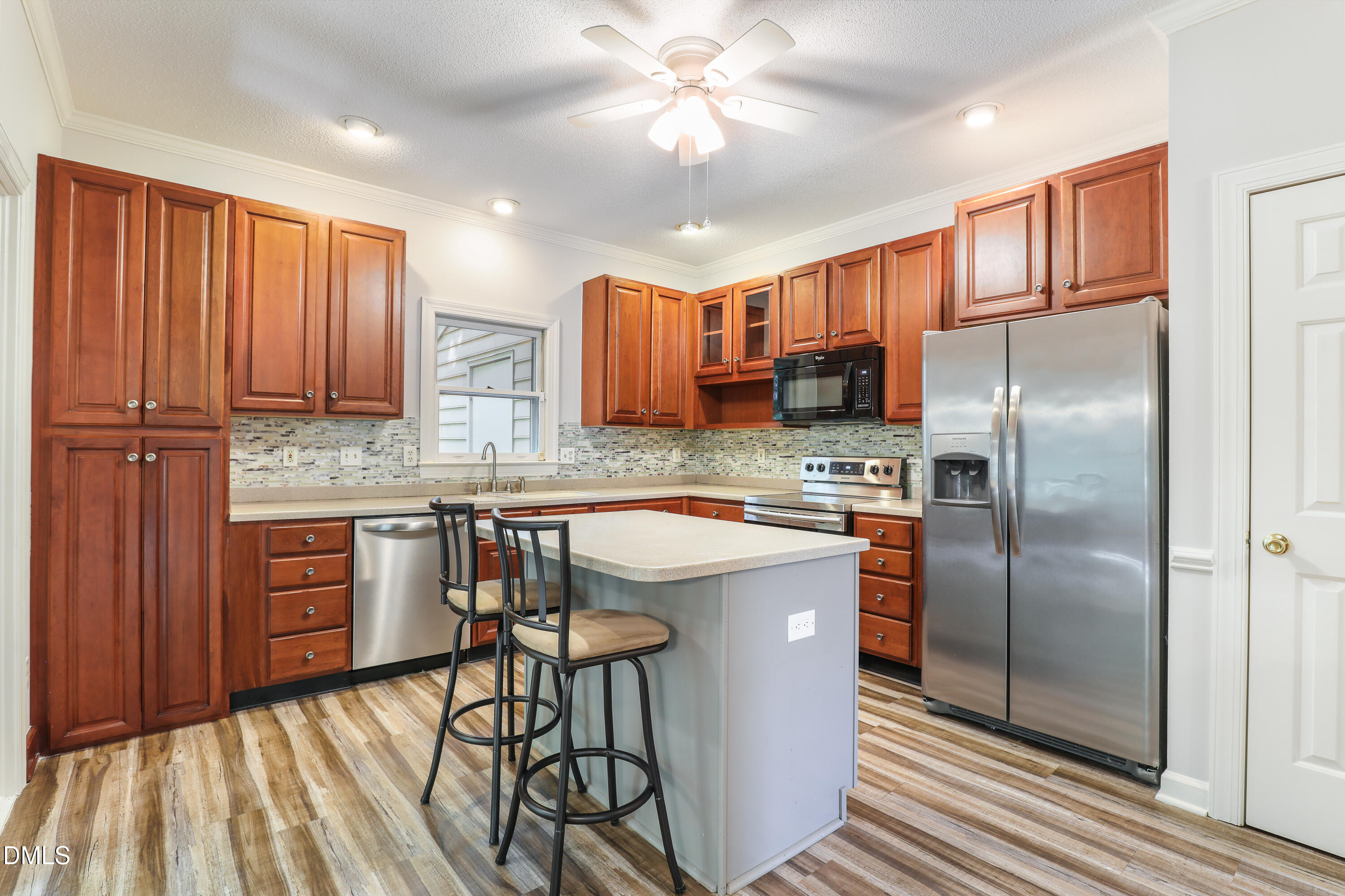 15 Preakness Drive Durham, NC 27713 - Photo 8 of 32 a kitchen with stainless steel appliances granite countertop a refrigerator a sink dishwasher a stove with wooden cabinets and floor