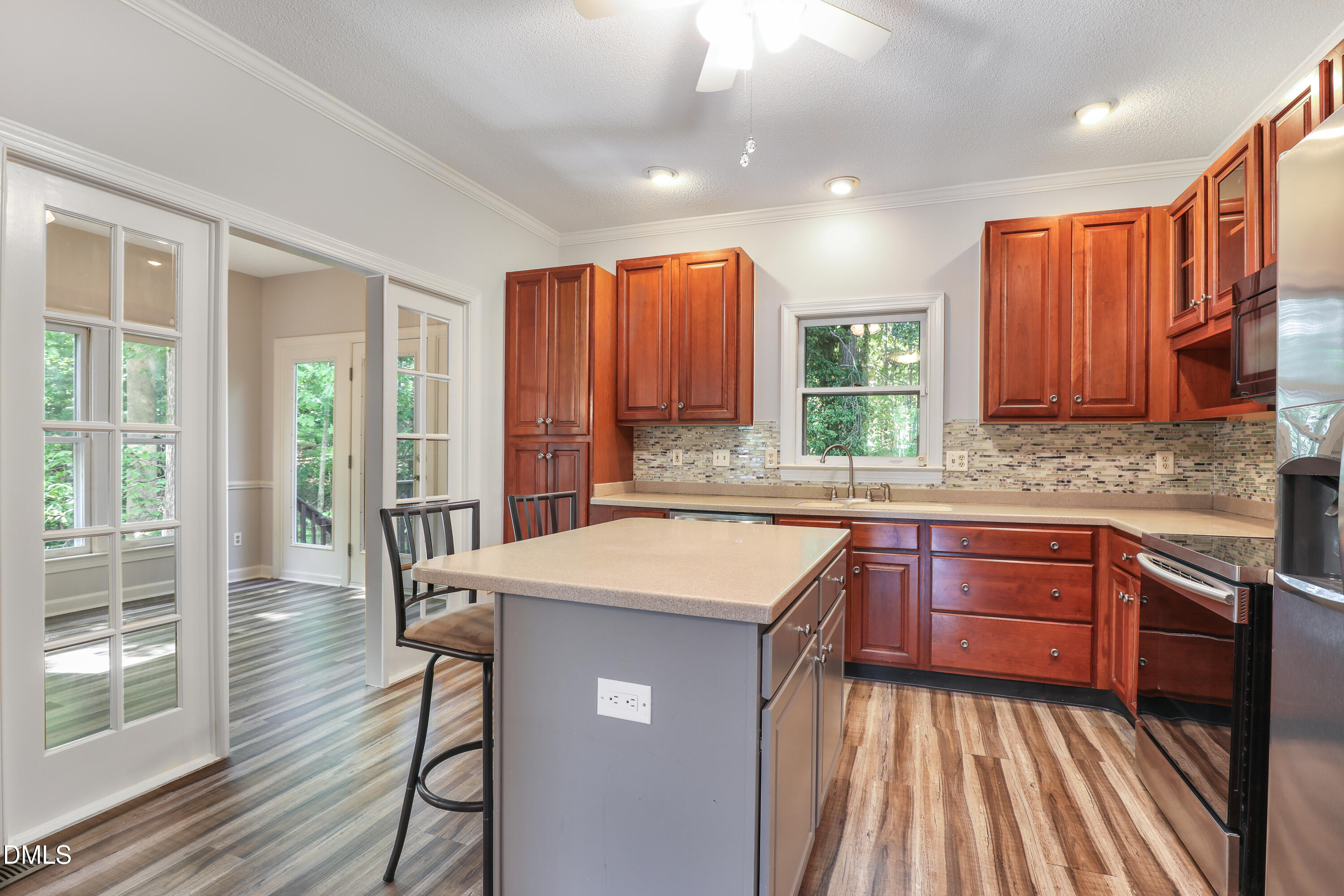 15 Preakness Drive Durham, NC 27713 - Photo 9 of 32 a kitchen with a sink stove and wooden cabinets