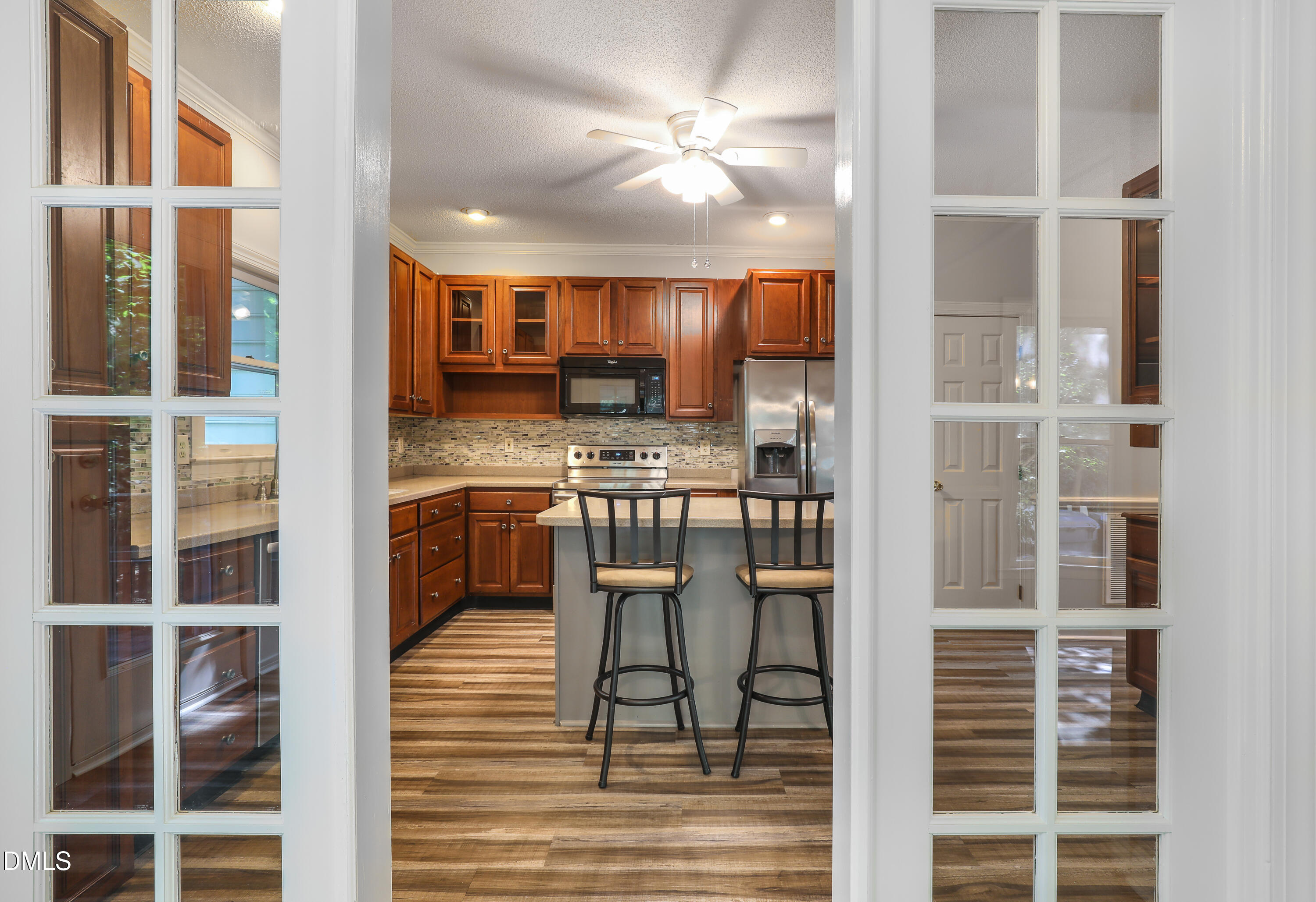 15 Preakness Drive Durham, NC 27713 - Photo 10 of 32 a kitchen with kitchen island granite countertop a refrigerator cabinets and chairs