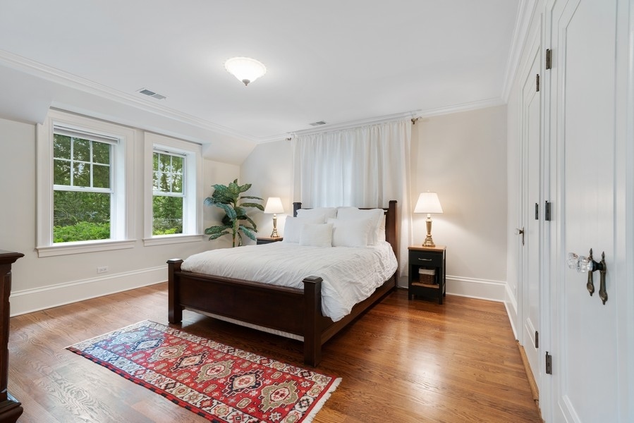 727 Indian Road Glenview, IL 60025 - Photo 16 of 58 a spacious bedroom with a large bed and a window
