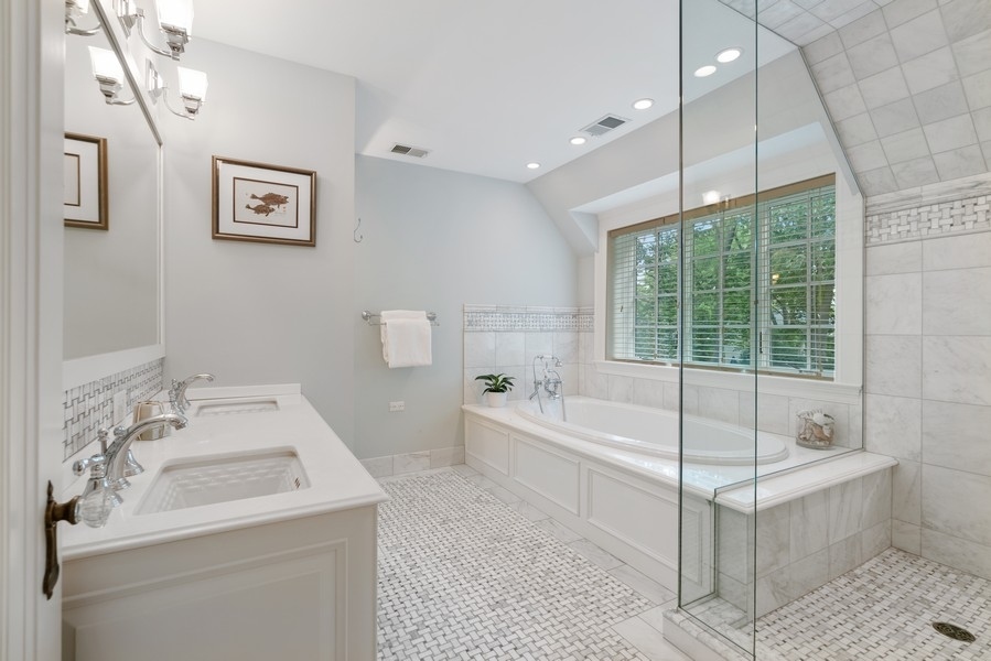 727 Indian Road Glenview, IL 60025 - Photo 18 of 58 a bathroom with a tub a sink and a large mirror