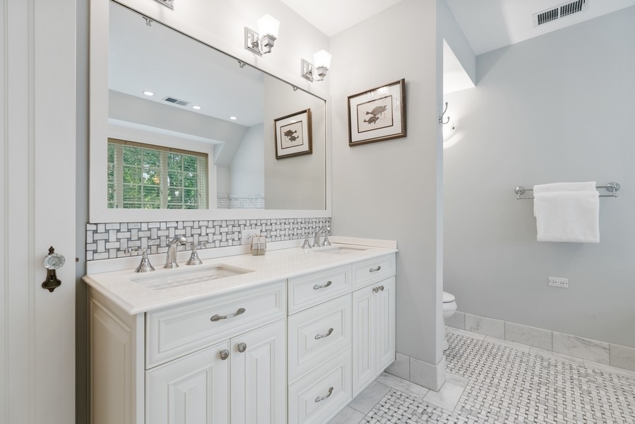 727 Indian Road Glenview, IL 60025 - Photo 19 of 58 a bathroom with a granite countertop sink mirror and a