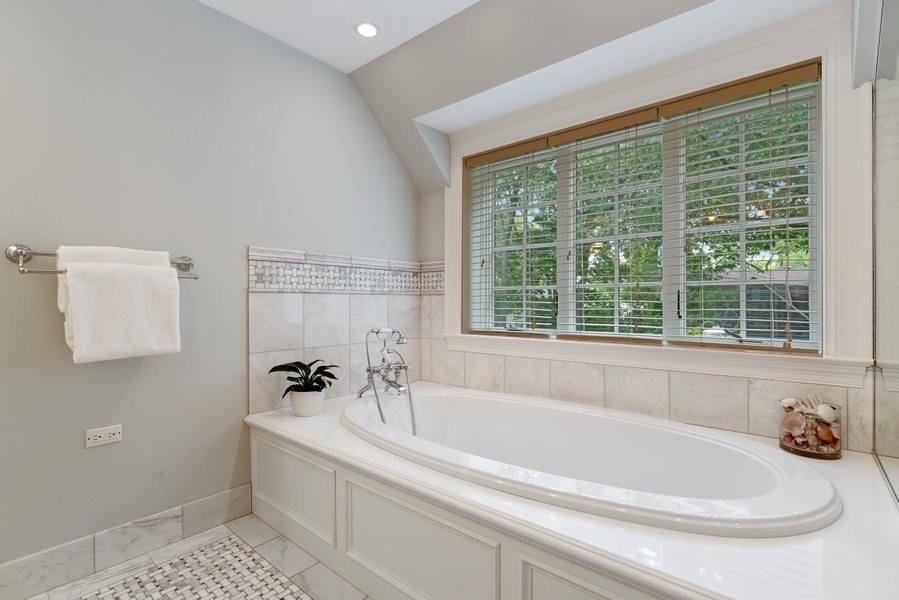 727 Indian Road Glenview, IL 60025 - Photo 20 of 58 a white bath tub sitting in a bathroom next to a window