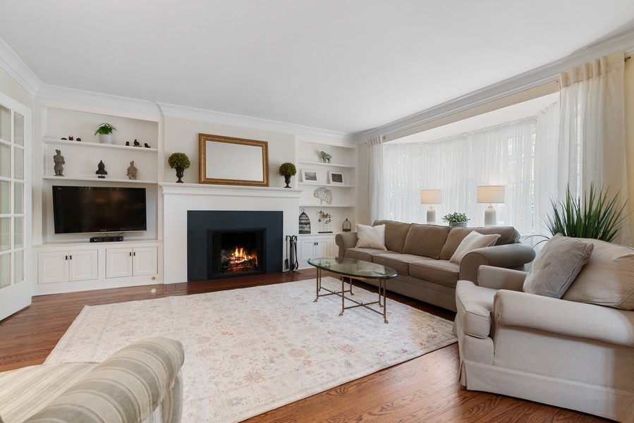 727 Indian Road Glenview, IL 60025 - Photo 3 of 58 a living room with furniture a flat screen tv and a fireplace