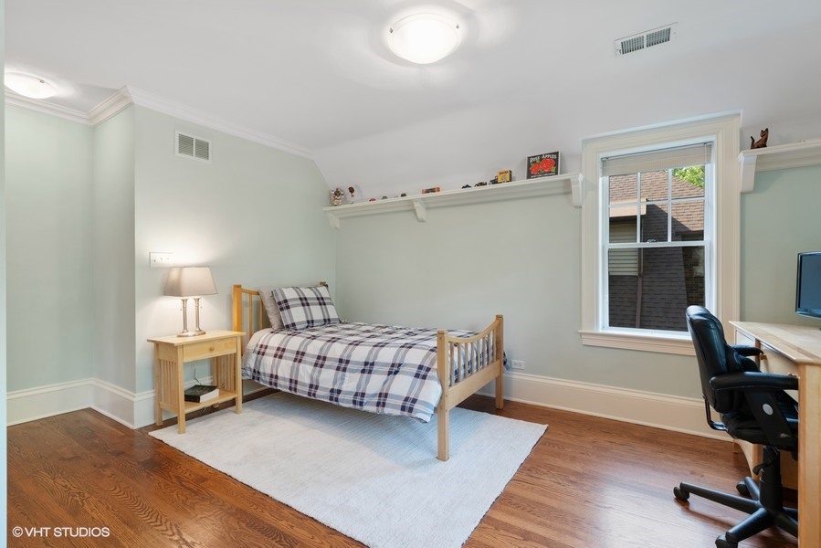 727 Indian Road Glenview, IL 60025 - Photo 24 of 58 a room with a bed and furniture