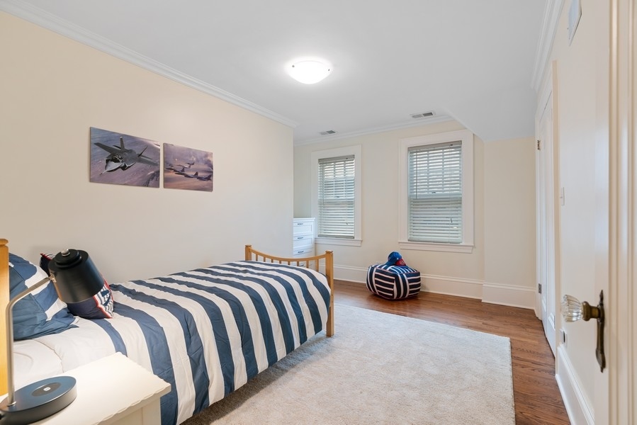 727 Indian Road Glenview, IL 60025 - Photo 26 of 58 a bedroom with a bed and a lamp