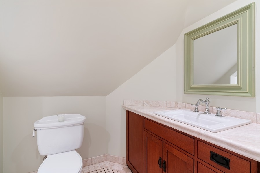 727 Indian Road Glenview, IL 60025 - Photo 31 of 58 a bathroom with a toilet a sink and mirror