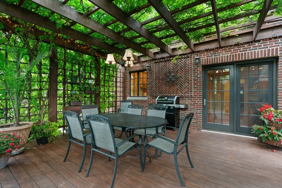 727 Indian Road Glenview, IL 60025 - Photo 42 of 58 a view of a patio with a table and chairs and potted plants