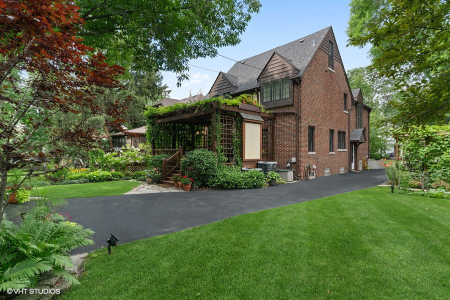 727 Indian Road Glenview, IL 60025 - Photo 48 of 58 a view of a white house next to a yard with big trees
