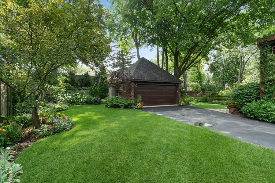 727 Indian Road Glenview, IL 60025 - Photo 50 of 58 a backyard of a house with plants and large trees