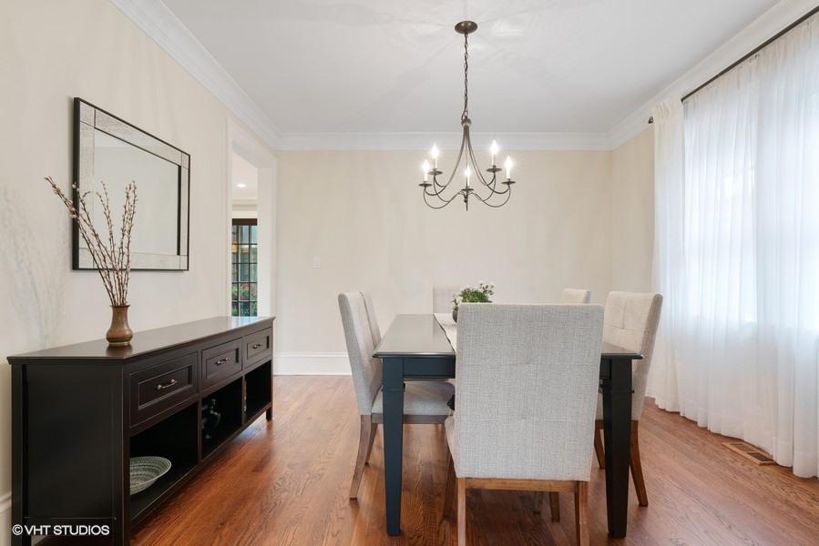 727 Indian Road Glenview, IL 60025 - Photo 7 of 58 a view of a dining room with furniture a chandelier and wooden floor