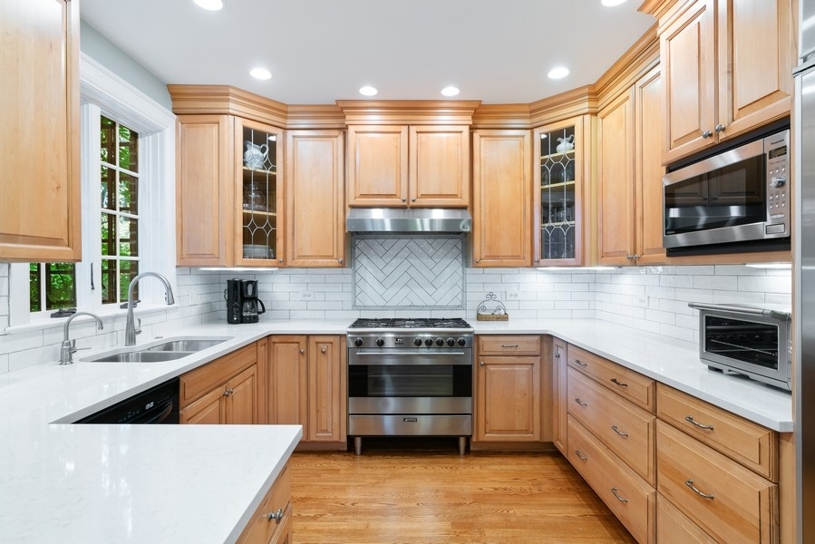 727 Indian Road Glenview, IL 60025 - Photo 9 of 58 a kitchen with stainless steel appliances a stove sink microwave and cabinets