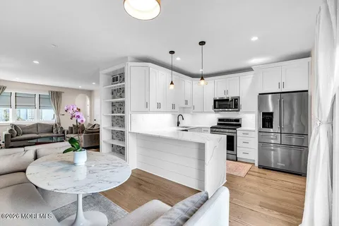 a kitchen with refrigerator cabinets dining table and chairs