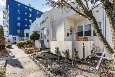 a view of a house with a yard and sitting area