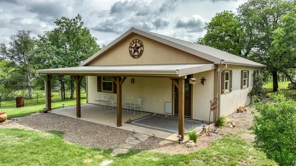 a living room with furniture and a kitchen