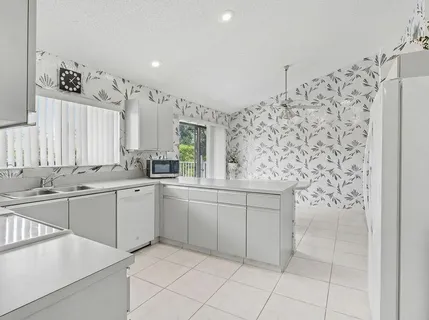 a kitchen with stainless steel appliances a sink and cabinets
